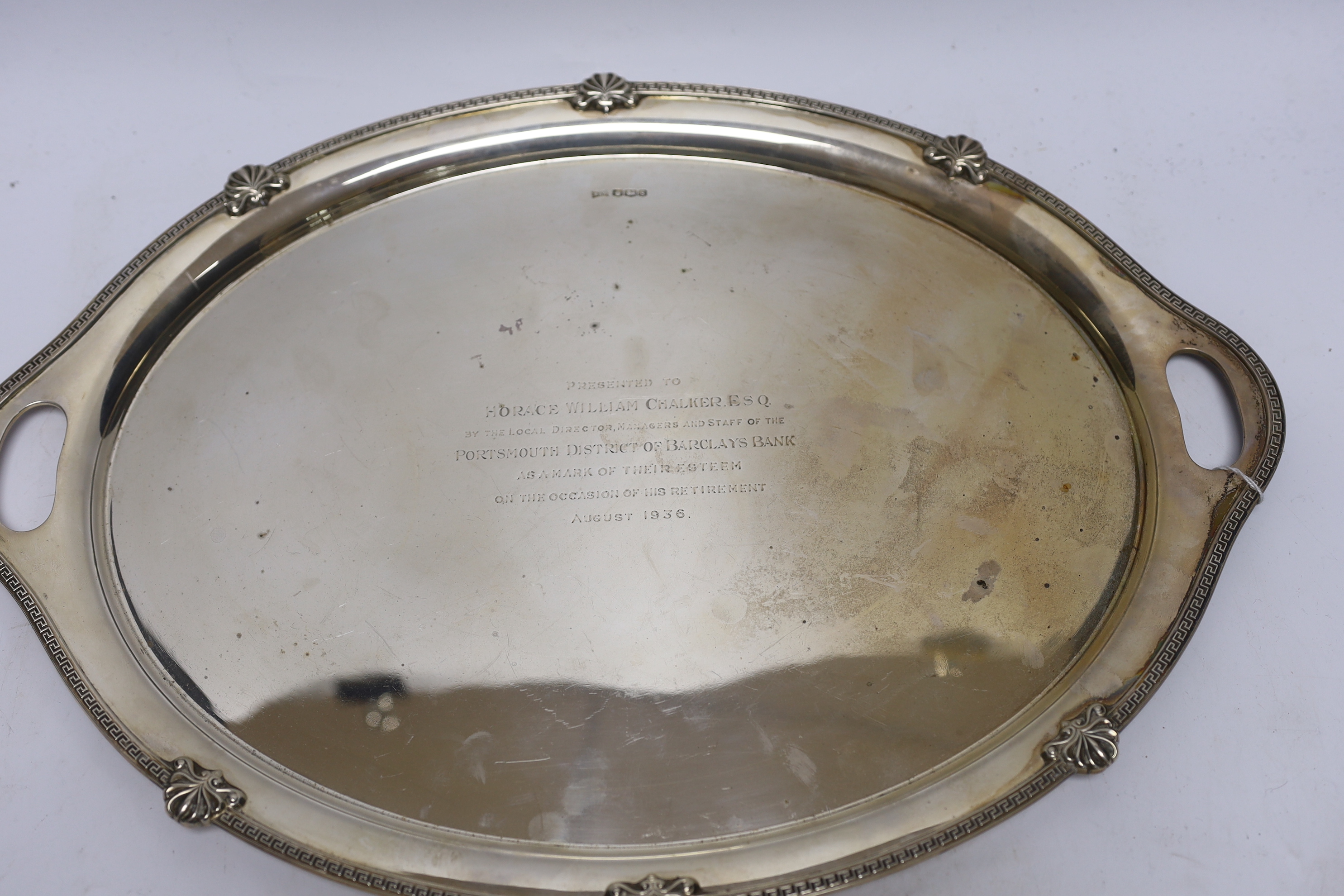 A George V silver oval presentation tea tray, with inset handles, Walker & Hall, Sheffield, 1935, 49.4cm, 54.2oz.